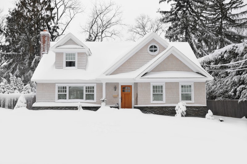 Snow-Covered Home With Furnace