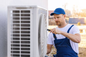 A technician performing a service on an air conditioning unit.