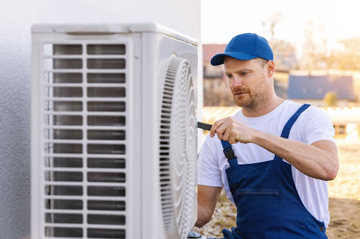 A technician performing a service on an air conditioning unit.