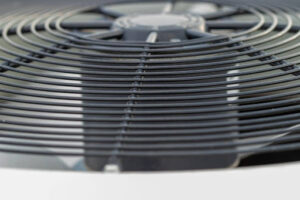 A close-up of an outdoor AC unit's fan.