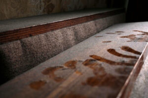 Dust and fingerprints on a wood surface.